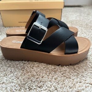 Black “Before We Begin” platform sandals